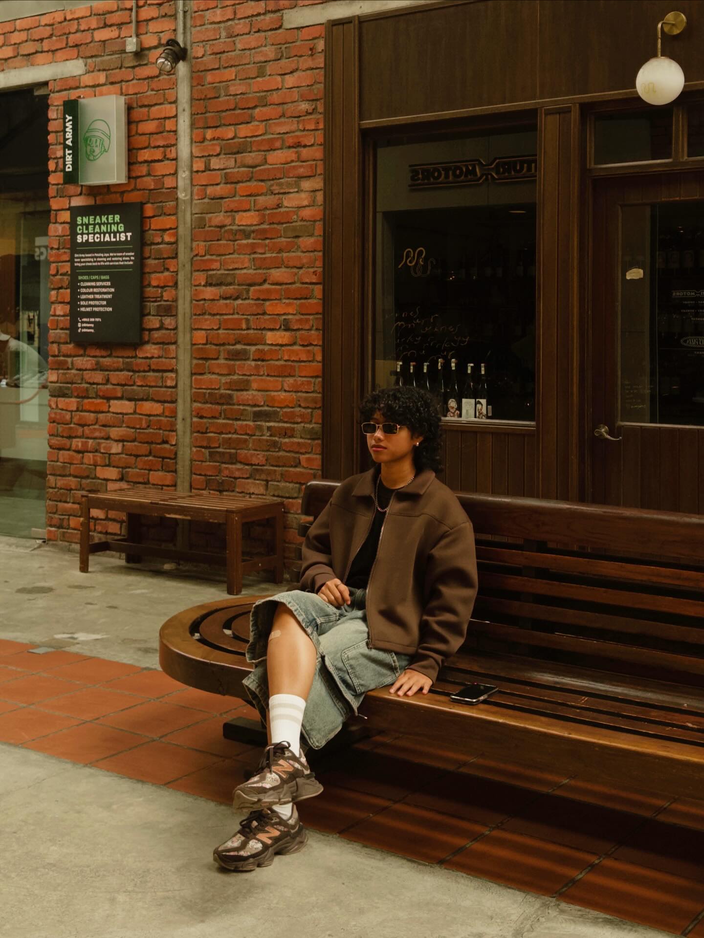 Piqa Rashid, Malaysian travel and lifestyle content creator, sitting outdoors in Kuala Lumpur